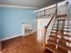 Inviting living room featuring a staircase, fireplace, wood floors and neutral paint at 2058 Sunset Point Rd # 11, Clearwater, FL 33765