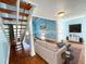 Inviting living room featuring hardwood floors, fireplace, modern furniture and staircase at 2058 Sunset Point Rd # 11, Clearwater, FL 33765