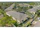 Overhead view of a residential condo complex surrounded by trees, sidewalks and manicured lawns at 220 Coquina Bay Dr, St Petersburg, FL 33705