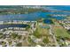 Scenic aerial view of a waterfront community featuring a pond, tennis courts, and sports fields at 220 Coquina Bay Dr, St Petersburg, FL 33705
