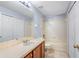 Bathroom features tiled flooring, a white tub and shower, and a wood vanity at 220 Coquina Bay Dr, St Petersburg, FL 33705