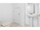 Bathroom features tiled floors, pedestal sink, and a toilet at 220 Coquina Bay Dr, St Petersburg, FL 33705