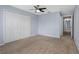 Bedroom features two closets, tan carpeting, and a ceiling fan at 220 Coquina Bay Dr, St Petersburg, FL 33705