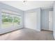 Comfortable bedroom with neutral carpeting, closet, and a window to provide natural light and a view at 220 Coquina Bay Dr, St Petersburg, FL 33705