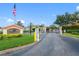 Community entrance with American flag, guardhouse, and visitor parking for easy guest access at 220 Coquina Bay Dr, St Petersburg, FL 33705