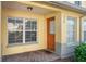Inviting front porch with a colorful door, tiled floor, and bright windows providing natural light at 220 Coquina Bay Dr, St Petersburg, FL 33705