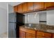Kitchen featuring wood cabinets, granite countertops, stainless steel appliances, and a breakfast bar at 220 Coquina Bay Dr, St Petersburg, FL 33705