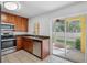 Well-lit kitchen with stainless steel appliances, granite countertops, and a sliding door to the patio at 220 Coquina Bay Dr, St Petersburg, FL 33705