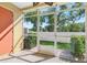 Enclosed patio showcases a white fence, manicured grass, and beautiful trees at 220 Coquina Bay Dr, St Petersburg, FL 33705