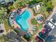 Overhead view of a serene kidney-shaped pool with a spa surrounded by tropical landscaping at 220 Coquina Bay Dr, St Petersburg, FL 33705