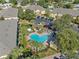 A lovely swimming pool area with lounge chairs and lush greenery in a condo community at 220 Coquina Bay Dr, St Petersburg, FL 33705