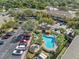Overhead shot of a community pool, surrounded by palm trees, parking, and several residential buildings at 220 Coquina Bay Dr, St Petersburg, FL 33705