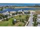 Breathtaking aerial perspective of waterfront houses near ocean, featuring well-kept green spaces and serene water views at 230 Sapphire Lake Dr # 201, Bradenton, FL 34209