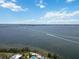 Expansive aerial view of waterfront community featuring serene bay waters and blue skies at 230 Sapphire Lake Dr # 201, Bradenton, FL 34209