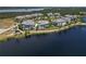 Scenic aerial view showcasing waterfront homes with landscaping, and water views at 230 Sapphire Lake Dr # 201, Bradenton, FL 34209