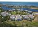 Panoramic aerial capture of waterfront homes with pristine green spaces, offering a serene living experience near the ocean at 230 Sapphire Lake Dr # 201, Bradenton, FL 34209