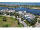 Amazing aerial view of houses near lake and ocean, surrounded by lush greenery and well-designed landscapes in a coastal setting at 230 Sapphire Lake Dr # 201, Bradenton, FL 34209