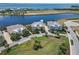 Stunning aerial view of waterfront homes with manicured lawns and serene lake and ocean surroundings at 230 Sapphire Lake Dr # 201, Bradenton, FL 34209