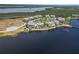 Picture-perfect aerial view of lakeside homes surrounded by lush greenery and a tranquil lake at 230 Sapphire Lake Dr # 201, Bradenton, FL 34209