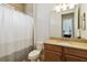 Well-lit bathroom with a granite vanity, a toilet, and a shower with a shower curtain for privacy at 230 Sapphire Lake Dr # 201, Bradenton, FL 34209