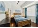 Cozy bedroom with a wood frame bed, natural light, and stylish decor creating a relaxing retreat at 230 Sapphire Lake Dr # 201, Bradenton, FL 34209