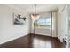 Bright dining room features a modern chandelier and a window overlooking tranquil water views at 230 Sapphire Lake Dr # 201, Bradenton, FL 34209