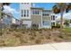 Charming exterior elevation of a light green home with well-maintained landscaping and a lush lawn at 230 Sapphire Lake Dr # 201, Bradenton, FL 34209