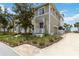 Charming two-story home featuring green siding, a quaint front porch, and a well-maintained, landscaped yard at 230 Sapphire Lake Dr # 201, Bradenton, FL 34209
