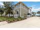Beautiful home featuring a front porch, a garage, well-maintained landscaping, and a view of the water at 230 Sapphire Lake Dr # 201, Bradenton, FL 34209