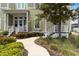 Two-story house with a charming front porch, lush landscaping, and a walkway leading to the entrance at 230 Sapphire Lake Dr # 201, Bradenton, FL 34209