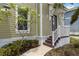 Inviting front entrance of home featuring covered porch, lush landscaping, and traditional architecture at 230 Sapphire Lake Dr # 201, Bradenton, FL 34209