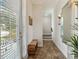 Bright foyer with tile flooring, a window with blinds, and a bench at 230 Sapphire Lake Dr # 201, Bradenton, FL 34209