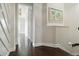 Bright hallway featuring beautiful dark hardwood floors and white trim and an eye-catching map wall decor piece at 230 Sapphire Lake Dr # 201, Bradenton, FL 34209