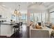 Open-concept living space featuring a kitchen with bar seating and a living area with stylish decor at 230 Sapphire Lake Dr # 201, Bradenton, FL 34209