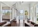 Bright living space featuring spiral staircase, large windows with water views, and comfortable seating at 230 Sapphire Lake Dr # 201, Bradenton, FL 34209
