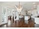 Open living space with modern chandelier, wood floors, and seamless transition to kitchen and other rooms at 230 Sapphire Lake Dr # 201, Bradenton, FL 34209