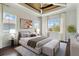 Serene main bedroom boasts a decorative ceiling, lots of natural light, and a sitting area at 230 Sapphire Lake Dr # 201, Bradenton, FL 34209