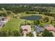 A picturesque aerial view of the property, highlighting its lush landscaping and serene lake views at 2301 Little Country Rd, Parrish, FL 34219