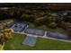 Aerial view of tennis courts, pickleball court, and lush trees at 2301 Little Country Rd, Parrish, FL 34219