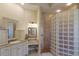 Cozy bathroom featuring a glass block shower, granite countertops, and charming decor at 2301 Little Country Rd, Parrish, FL 34219