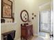 Elegant bathroom featuring dark fixtures, carved vanity, and decorative accents for a luxurious feel at 2301 Little Country Rd, Parrish, FL 34219
