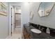 Elegant bathroom with a black granite countertop, dual sinks, framed mirrors, and a shower-tub combo at 2301 Little Country Rd, Parrish, FL 34219