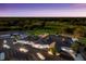 Dusk aerial view of the clubhouse showcasing the golf course and surrounding nature at 2301 Little Country Rd, Parrish, FL 34219
