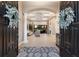 Grand foyer featuring a decorative rug, arched entryway, and coffered ceilings at 2301 Little Country Rd, Parrish, FL 34219