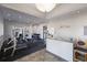 Bright gym with weightlifting equipment and rubber floor, and a welcome desk with granite counter at 2301 Little Country Rd, Parrish, FL 34219