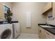 Efficient laundry room with built-in cabinets, folding counter space, and a window for natural light at 2301 Little Country Rd, Parrish, FL 34219