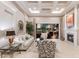 Cozy living room featuring a fireplace, coffered ceilings, and access to the patio at 2301 Little Country Rd, Parrish, FL 34219