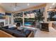 Expansive outdoor living area with screened-in pool, summer kitchen, fireplace, and comfortable seating at 2301 Little Country Rd, Parrish, FL 34219