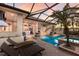 An inviting screened-in pool and outdoor living area with a bar perfect for relaxation and entertainment at 2301 Little Country Rd, Parrish, FL 34219
