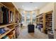 Bright walk-in closet with custom shelving, a central island, and seating near large windows at 2301 Little Country Rd, Parrish, FL 34219